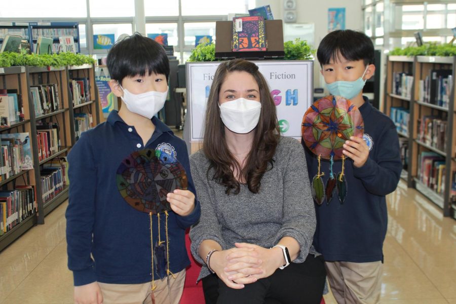 Mrs. Gum poses proudly with her two students in the library, David (left) and Joseph (right).