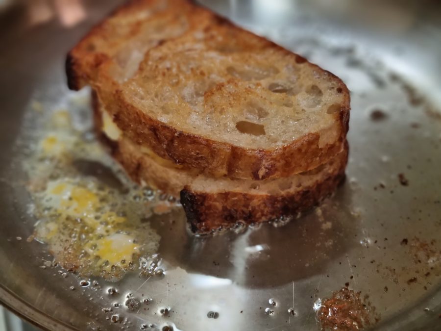 Beautifully browned, crispy slices of sourdough bread house three kinds of cheese. Photo by Colin Ji.