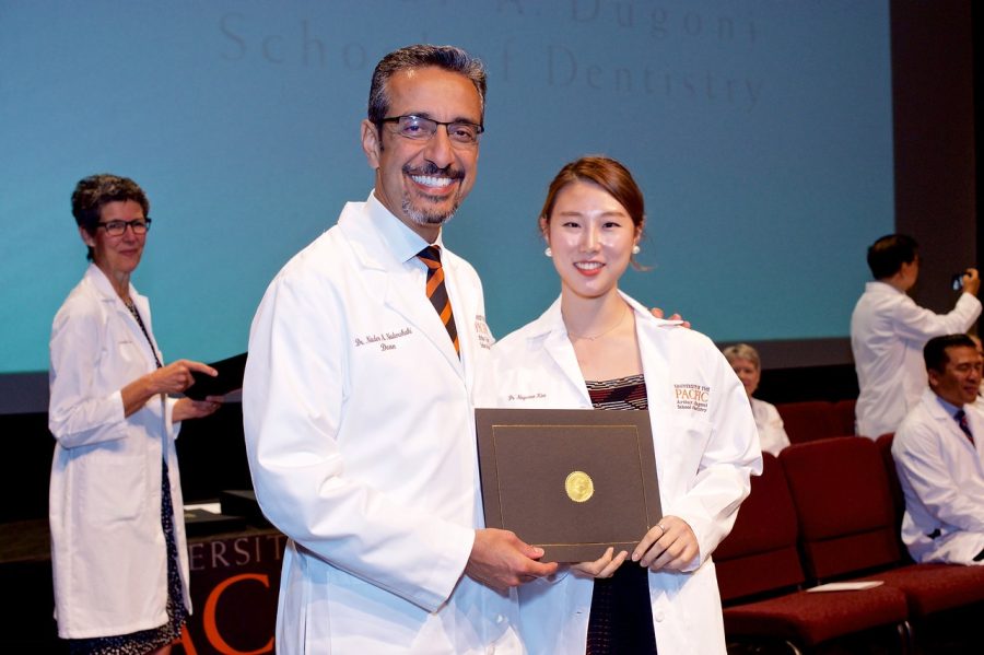 Christina glady receives her certificate during the second year White Coat ceremony. Photo provided by Christina Kim.