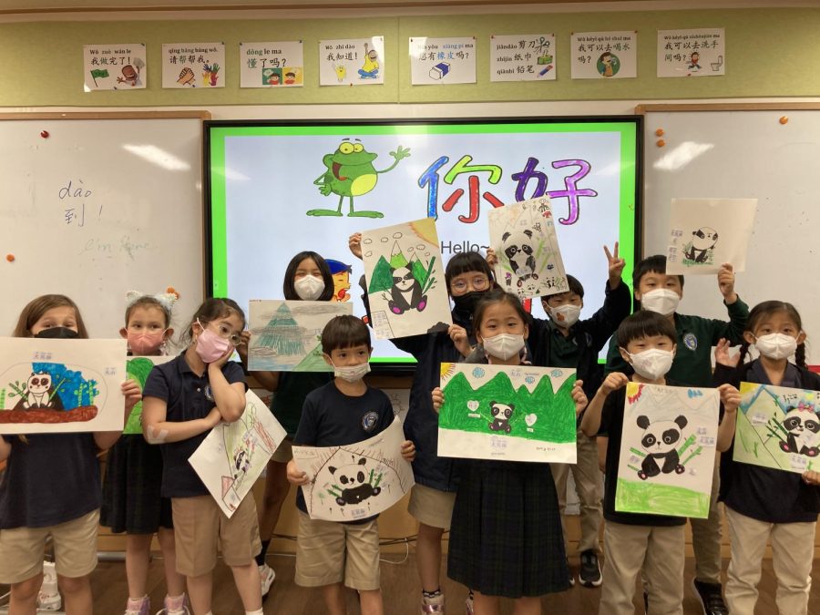 Members of the Chinese Culture club share their panda drawings with each other. Photo by Solah Han.