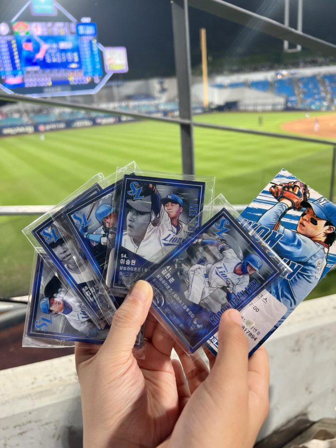 A game was projected on the scoreboard. The numbers on the board matched my ticket so I won these baseball cards. Photo by Caden Chang.
