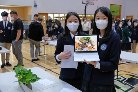 Isabella and Jessica proudly present their STEM project about plant science. Photo by Jackson Chiang.