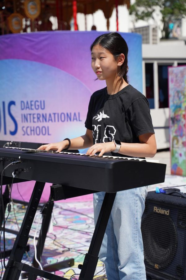 Jio Kim in 8th grade plays her keyboard with joy. 