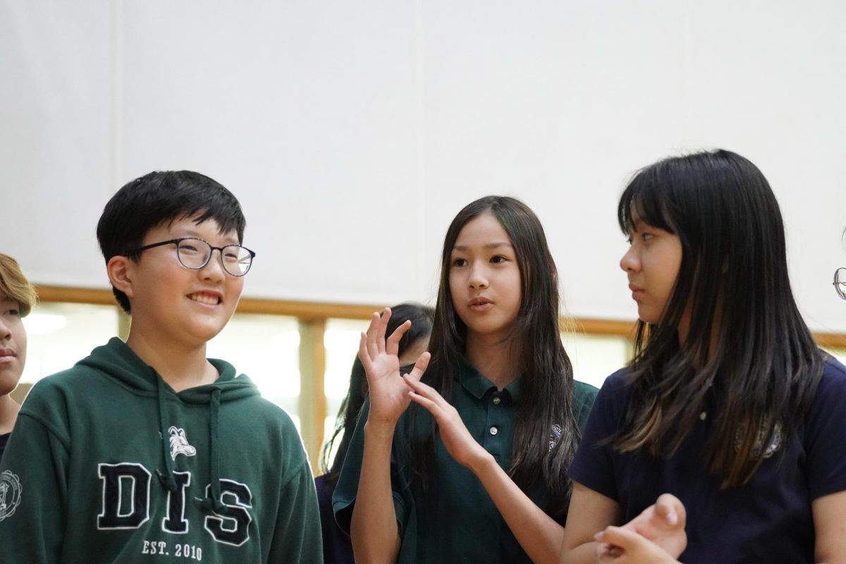 Erin Moore, Bella Choi, and Phillip Yoon in seventh grade debate on whether everybody is racist to some degree. 