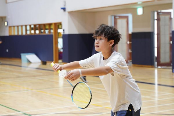 Jason Kim in eighth grade steadies his posture for an ace serve down the court. Photo by Raina Lee.