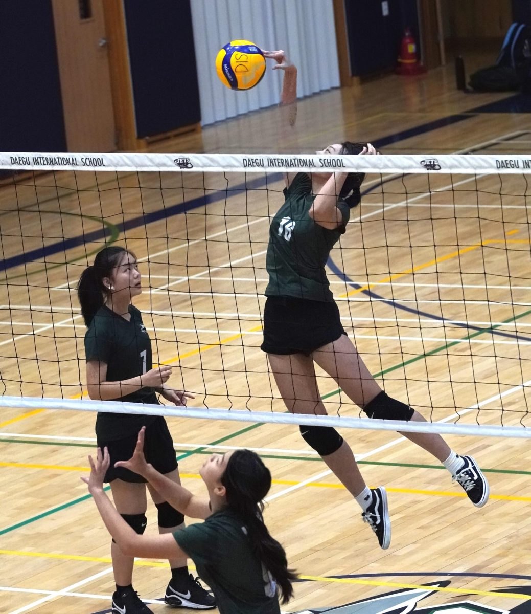 Apple Jun tosses a perfect set for her middle blocker Sunny Oh. Oh leaps to spike the ball. 
