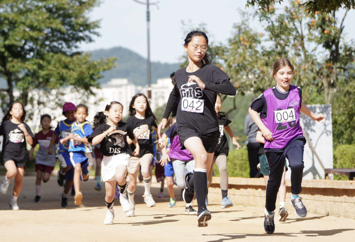 Tracy Kim in fifth grade kicks into maximum overdrive after the countdown. The other runners follow her lead. 