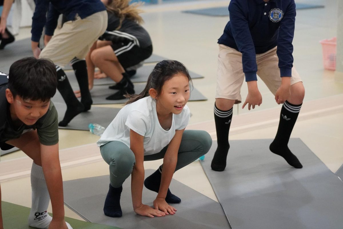 Allie Moon in fourth grade prepares to hop on the yoga mat following the instructors. 