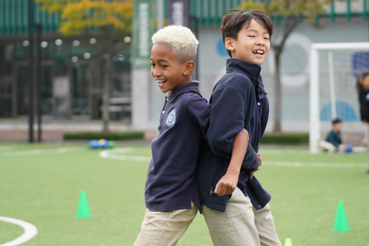 Arthur Silva and Jacob Lee in fourth grade have fun as they sprint toward the finishing line. Photo by Anna Yoon. 