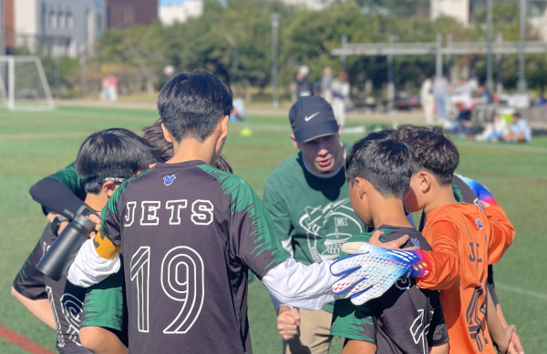 Coach Gall calls for a huddle. His inspirational pep talk before the intense game gets the Jets hearts pumping. 