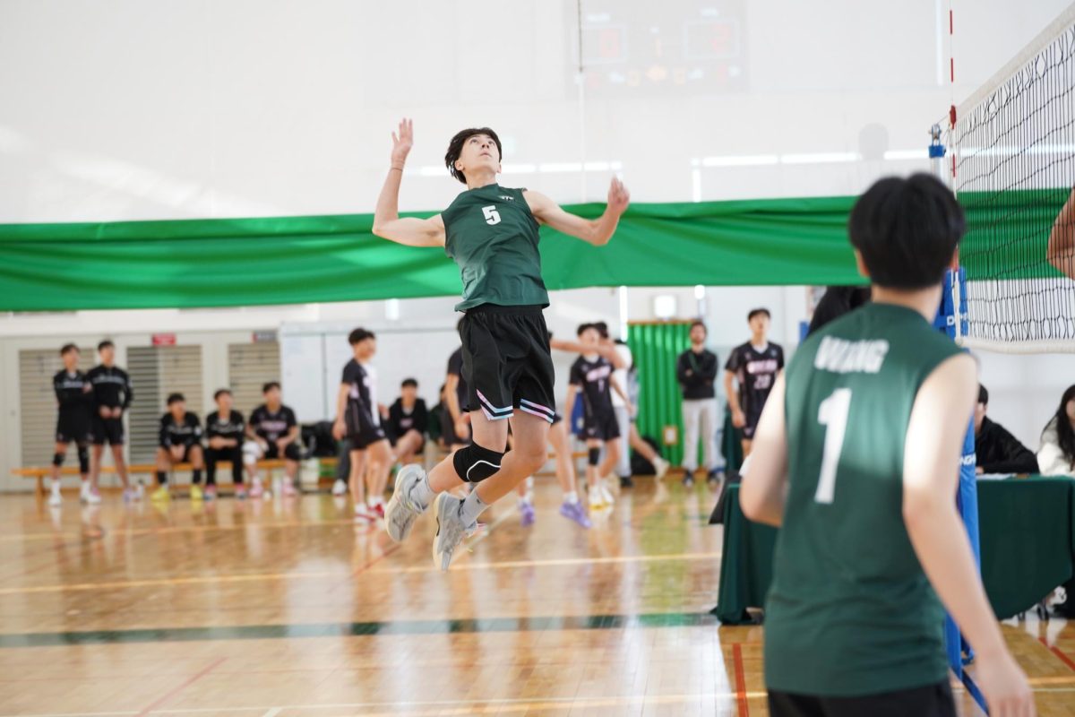 Ethan Rossmeisl (number 5) soars into the air to slam the volleyball. Great placement from Dylan Wang makes it easier for Ethan to take a point for the Jets.