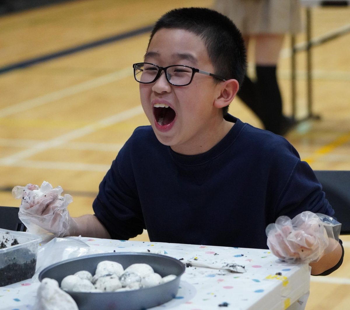 Fifth grader Miles Long savors the yuanxiao after a long meticulous culinary process. He screams out as the umami of the treat floods through his senses. 