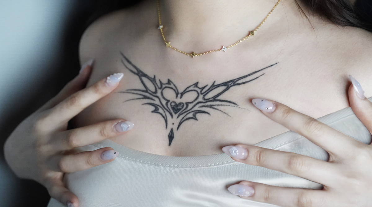 Nadia Woo showcases her neotribal-style chest tattoo designed by a rising artist “Only”. This was the artist’s seventh official client, yet the stunning quality shows the immense preparation behind the scenes. Only continues to push boundaries with their art despite the illegality of their profession in South Korea. Photo by Ava Cho and Lewis Kim.