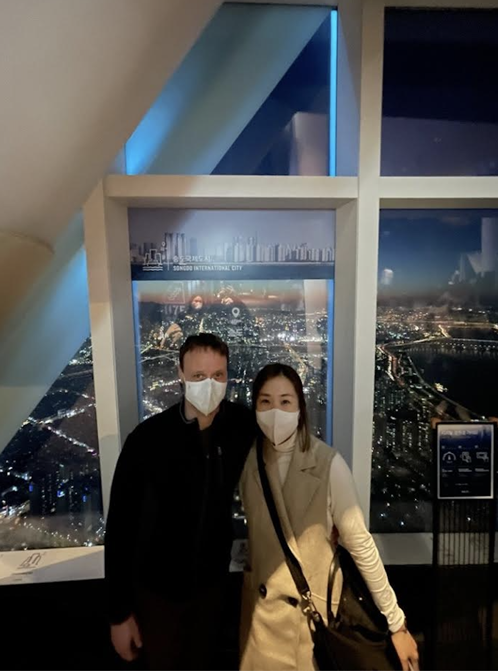 At Seoul Sky, Lotte World Tower, Mrs. Je and her husband capture a memory before her son was born. The couple glances at the view of Seoul from the tower. Photo courtesy of Mrs. Je.
