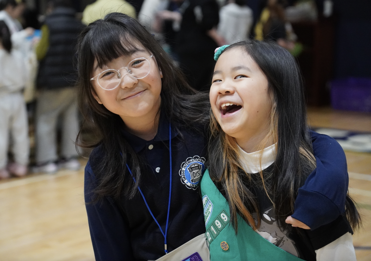 Sixth grader Olivia Cho and fifth grader Lily Kim beam and shriek with laughter. They goof around and have the time of their lives. 