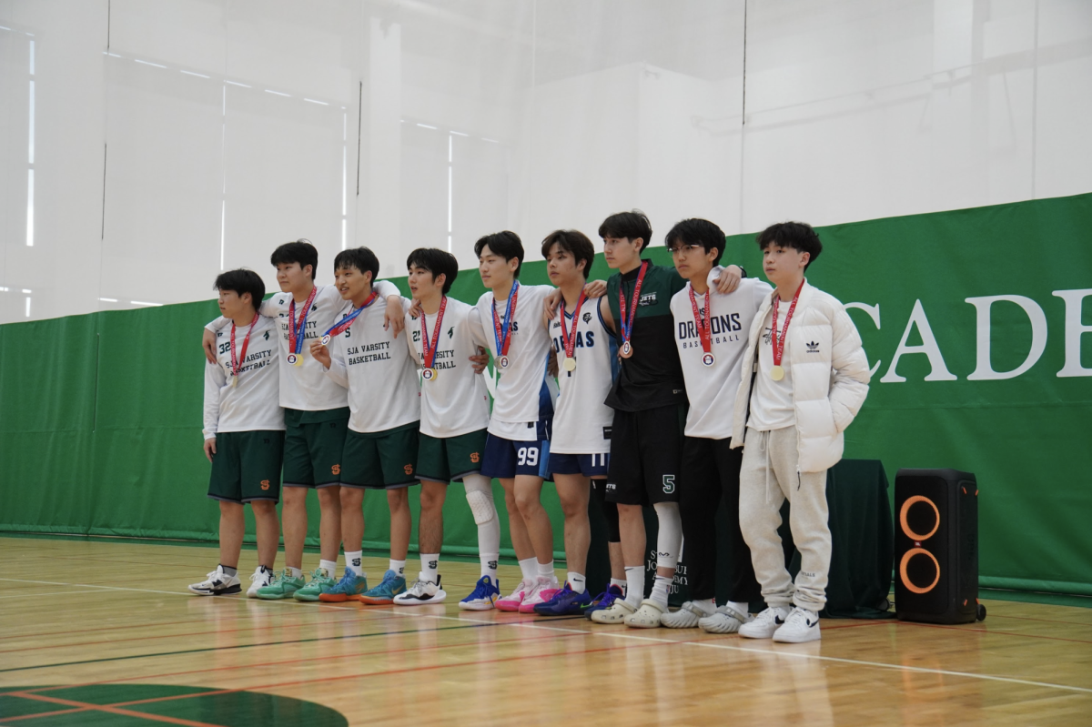 Ethan Rossmeisl (number 5) receives the all-tournament team medal along with 9 other members from different international schools. The top scorer and leader of the Jets, Ethan wins his back-to-back medal. 