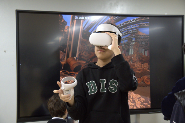 Yujun Piao tries out his AI Avatar before his groups turn to present. Yujun had a lot of fun with this project since it allowed him to experiment in the field of robotics. 
