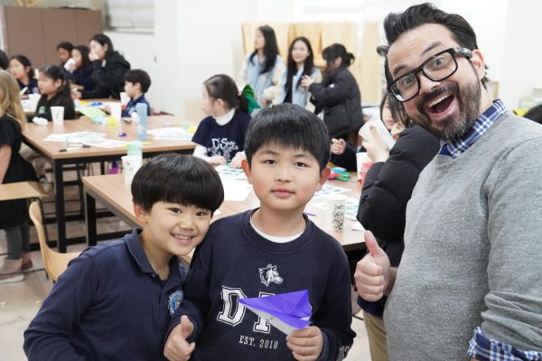Second graders Yian Chang and Leo Yun craft a paper airplane with the support of Mr. Gum. The younger Jets created yet another aerial masterpiece. 