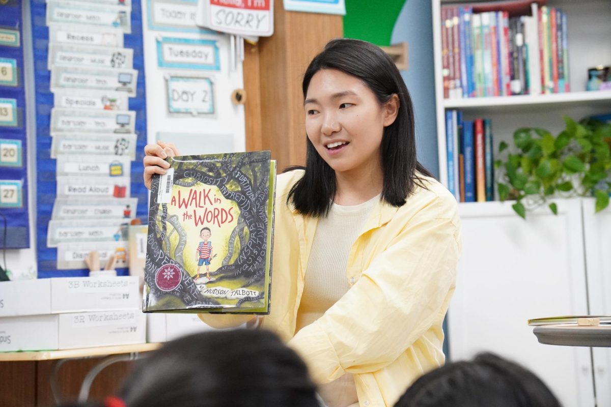 Ms. Shin reads a book about a boy who’s afraid of long words. She encourages the third graders by teaching them about the beauty of language and literature. 