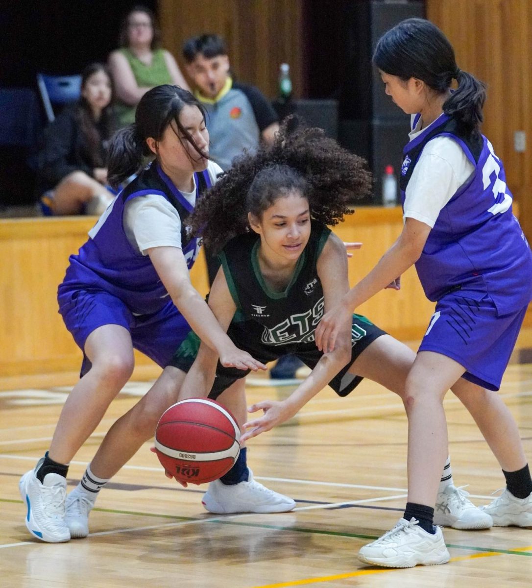 Small forward Luisa Silva (20) holds tight until her teammates come for help. Her aggressiveness scares the Bears away. 