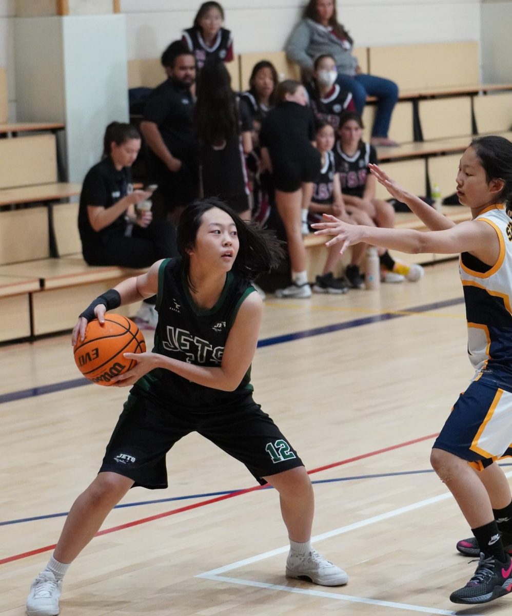 Seventh grader Yul Sakong jab steps to fake the opponent and find a way towards the basket. Her easy layup brings up the team morale.