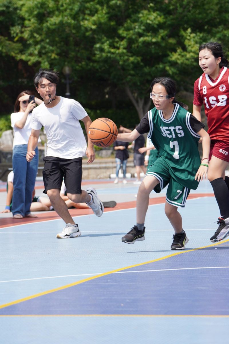 5th grader Akari Kojima turns the corner swiftly to juke the defender. She utilizes her quickness to blow by her defender. Photo by Ethan Rossmeisl.