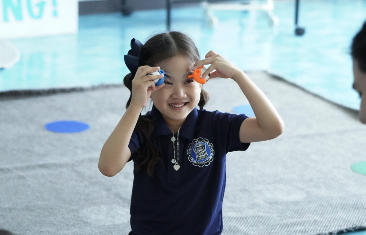 Kindergartener Lani Lee doubles her eyes with a dash of blue and orange. Her friends feel her aura with the eyeballs. 