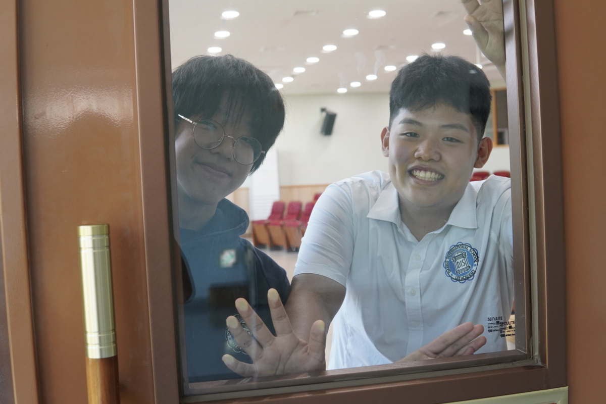 Juniors William Seok and Brian Cho take a window selfie in the renovated presentation hall. 