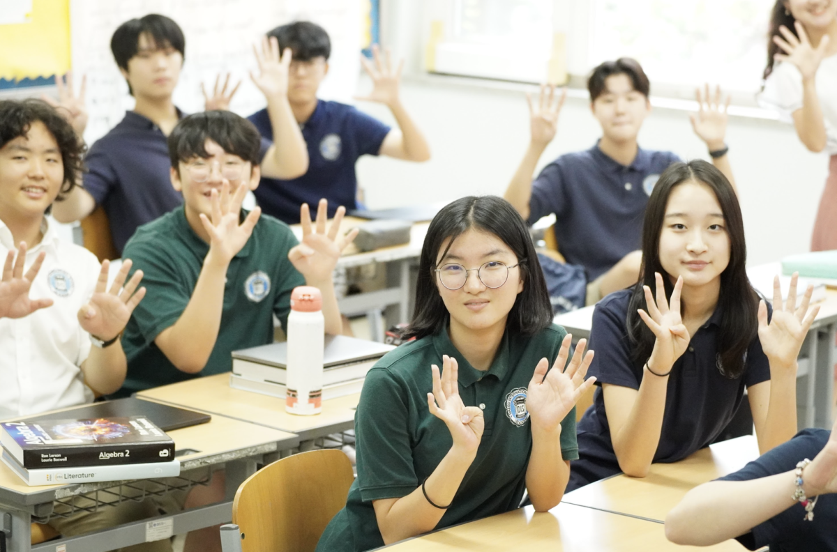 The new freshmen hold out nine fingers, as they mark the first day of their high school years. 