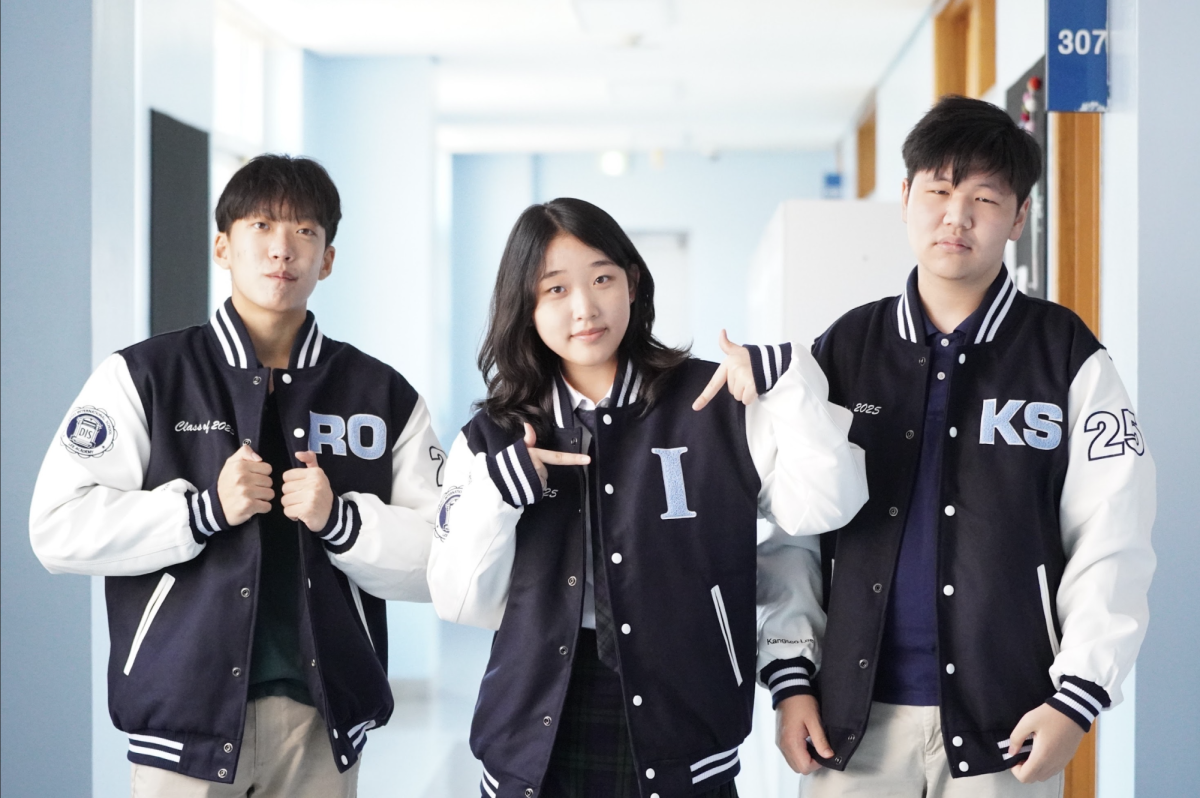 Senior Ryan Oh, Isabella Lee and Kyle Lee proudly wear their varsity jackets despite the sweltering heat. Some waited for a decade for their senior status. 