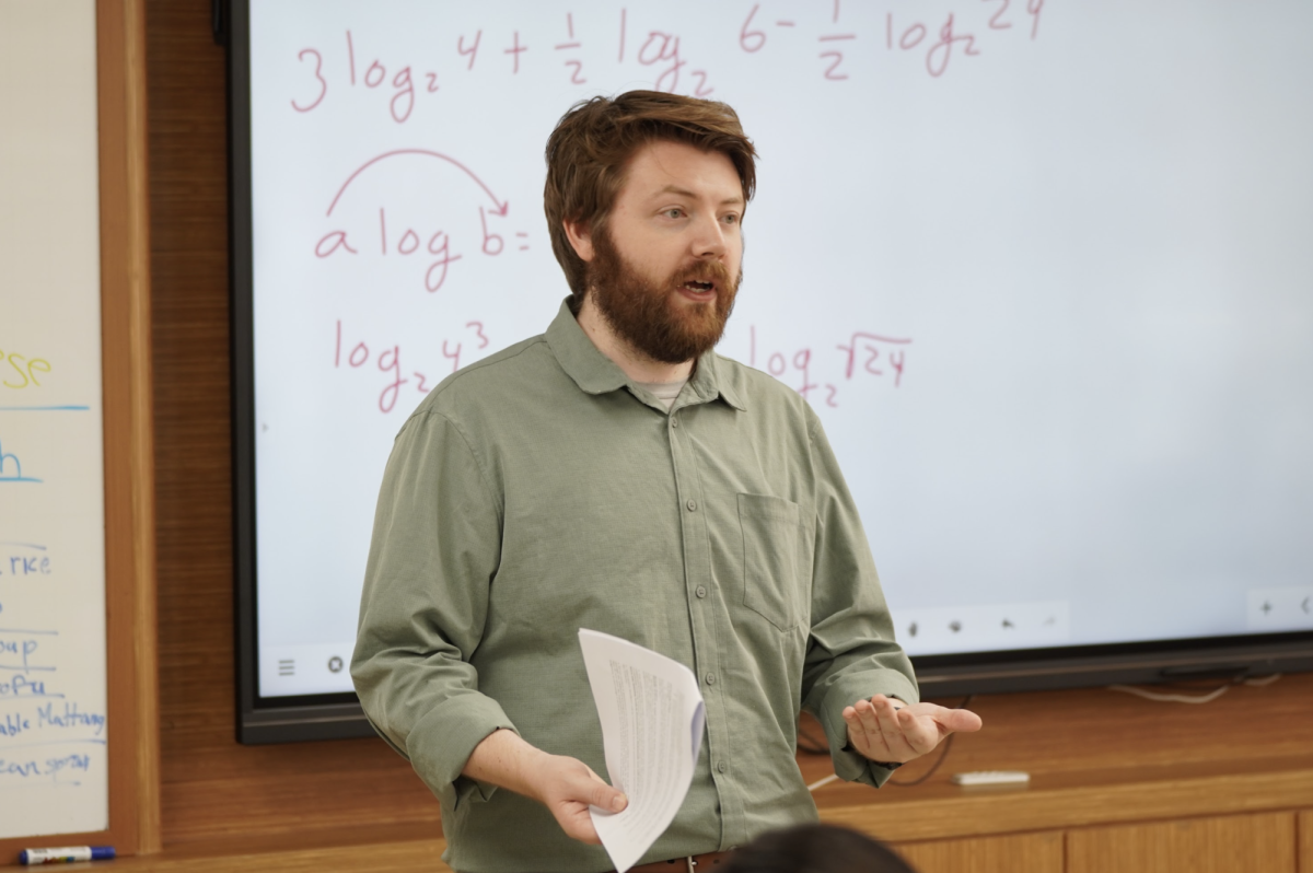 Mr. Coleman jumps into logarithmic functions to greet sophomore students. The students know to expect a lot of numbers, functions, and Mr. Coleman's beard. 