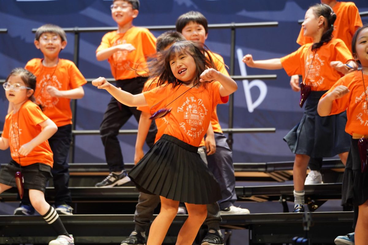 Selena Ahn in first grade twists her body to the cheerful music. Her skirt dances in the air. 