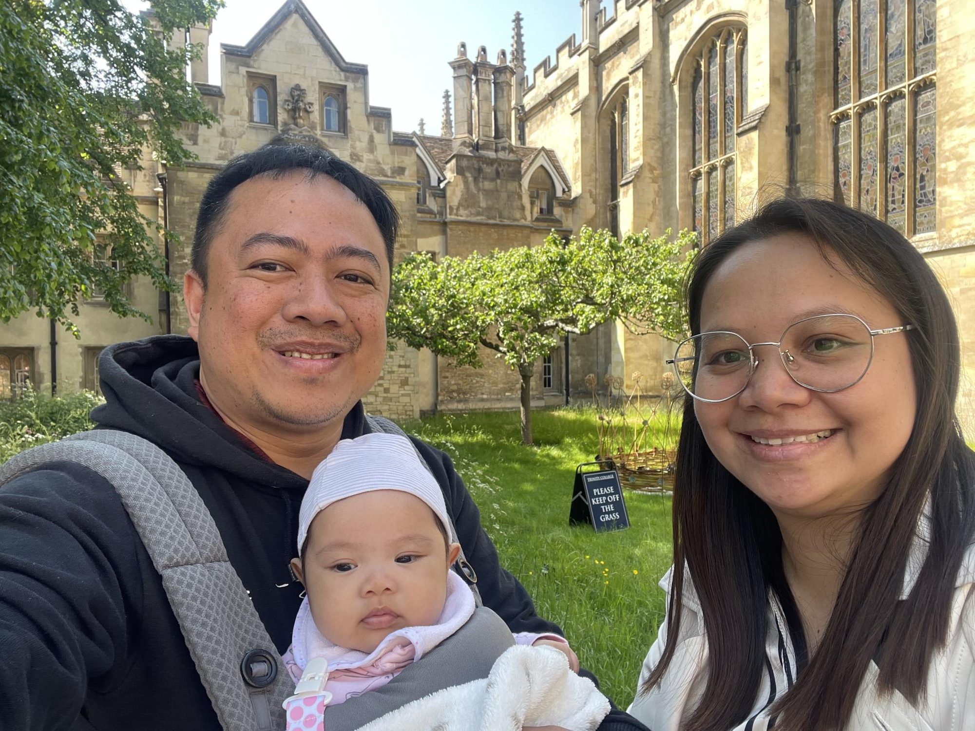 Beside Newton's apple tree at the University of Cambridge, Mr. Hortezula and his family share a moment of wonder and inspiration. Photo courtesy of Mr. Hortezuela.