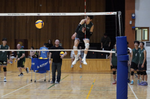 Ethan Rossmeisl (number 5) shocks the audience with his leaping ability. He takes flight and dents the floor with his powerful spike.