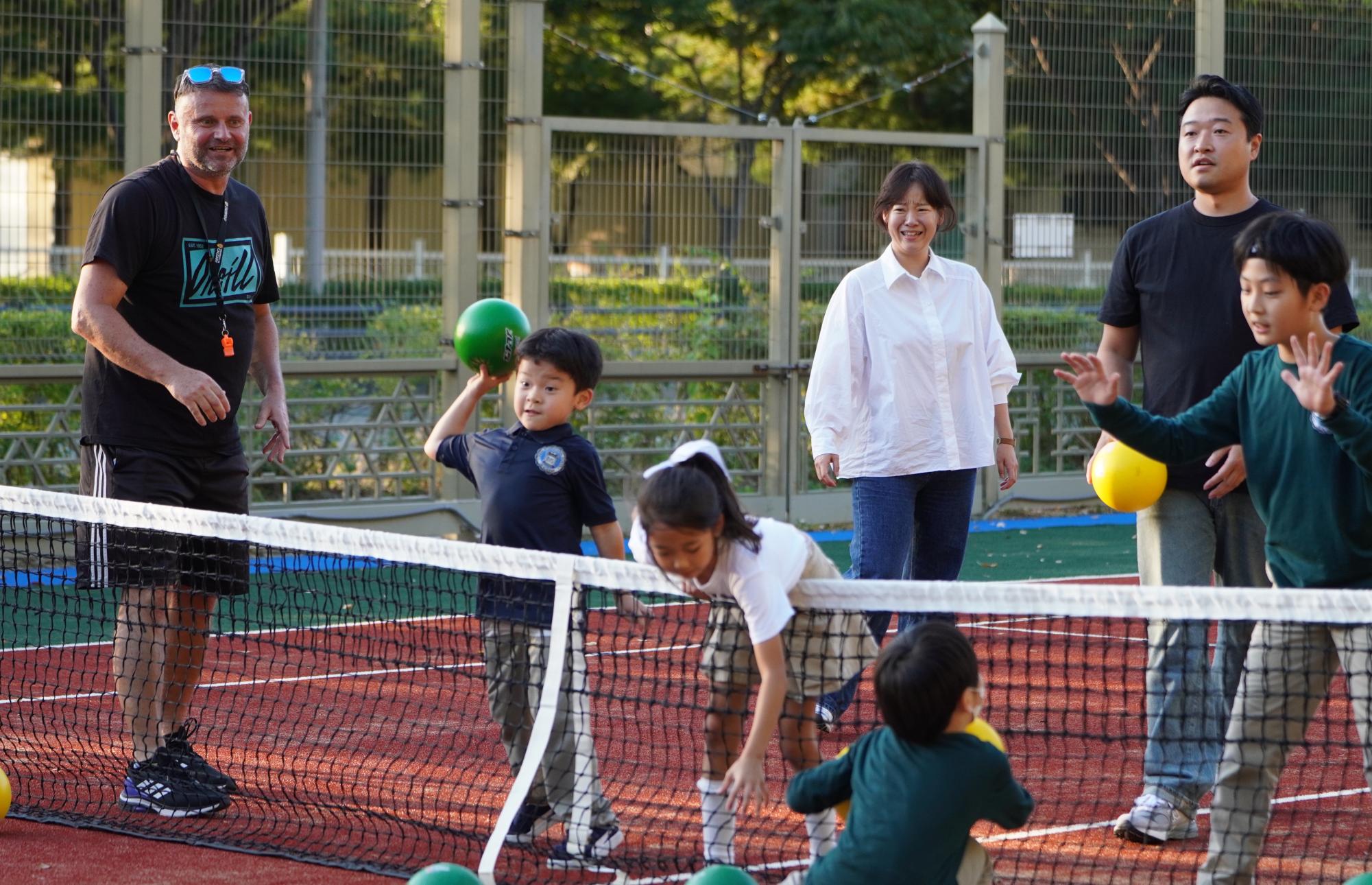 Brian Hwang in first grade throws the dodgeball across the court. He aims to take his friend out for the win. 