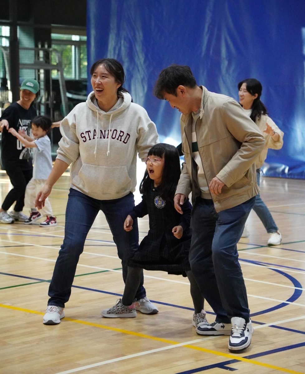 First-grader Arin Son enjoys zumba with her parents. The family succeeds a difficult maneuver reflecting their adept teamwork. Photo by Hailey Tzou