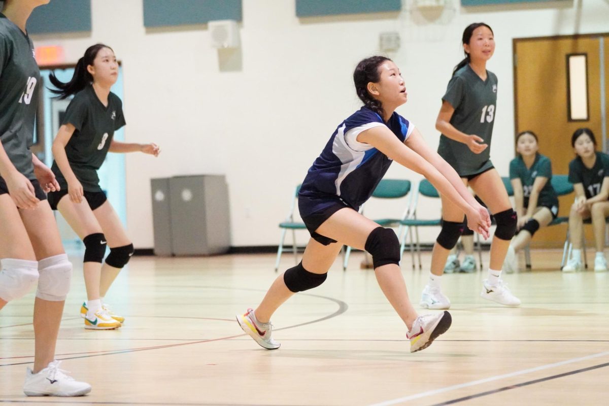 Libero Jio Kim (6) reacts in the nick of time, keeping the the ball alive. Her sharp defense allows the Jets to widen the score gap against DMHS.