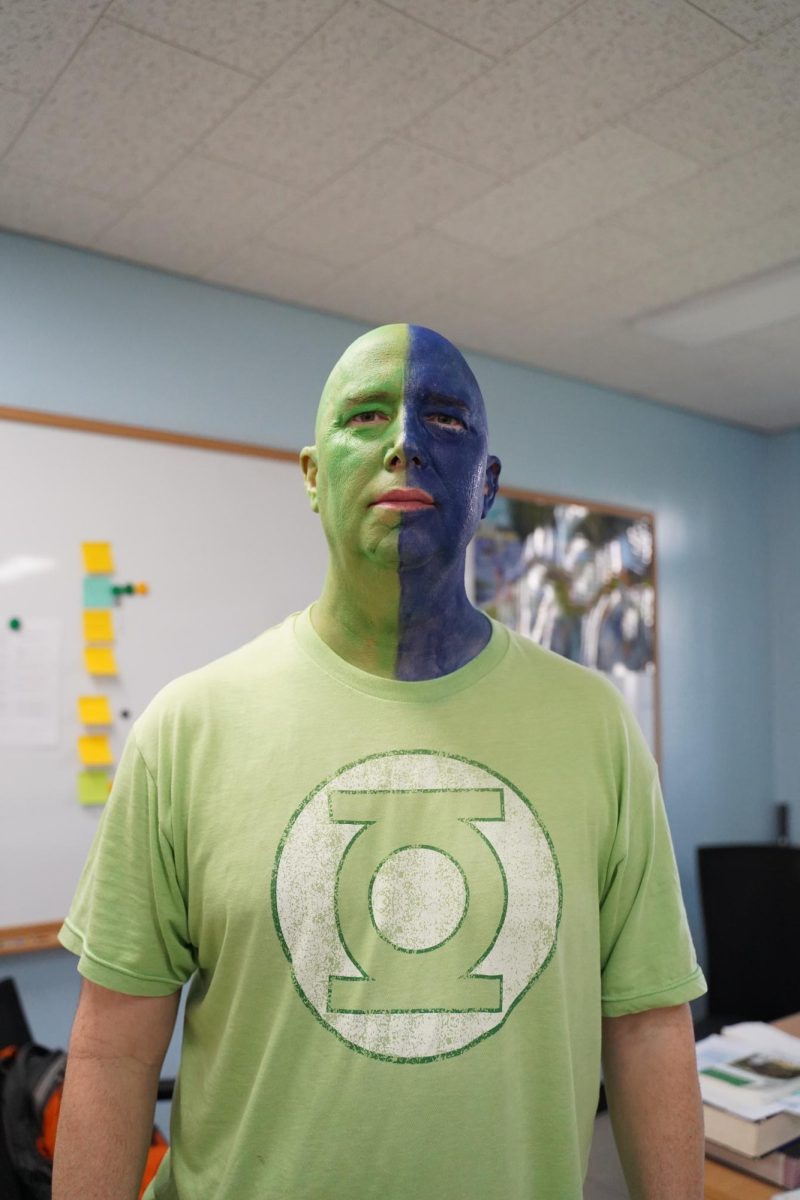 High school English teacher Mr. Hinkle boasts his DIS spirit. His perfect blend of blue and green from last year raises anticipation for his outfit this year. 