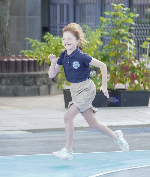 4th grader Louise Marechal sprints towards the finish line. She attempts to win her peers and secure the 1st place. 