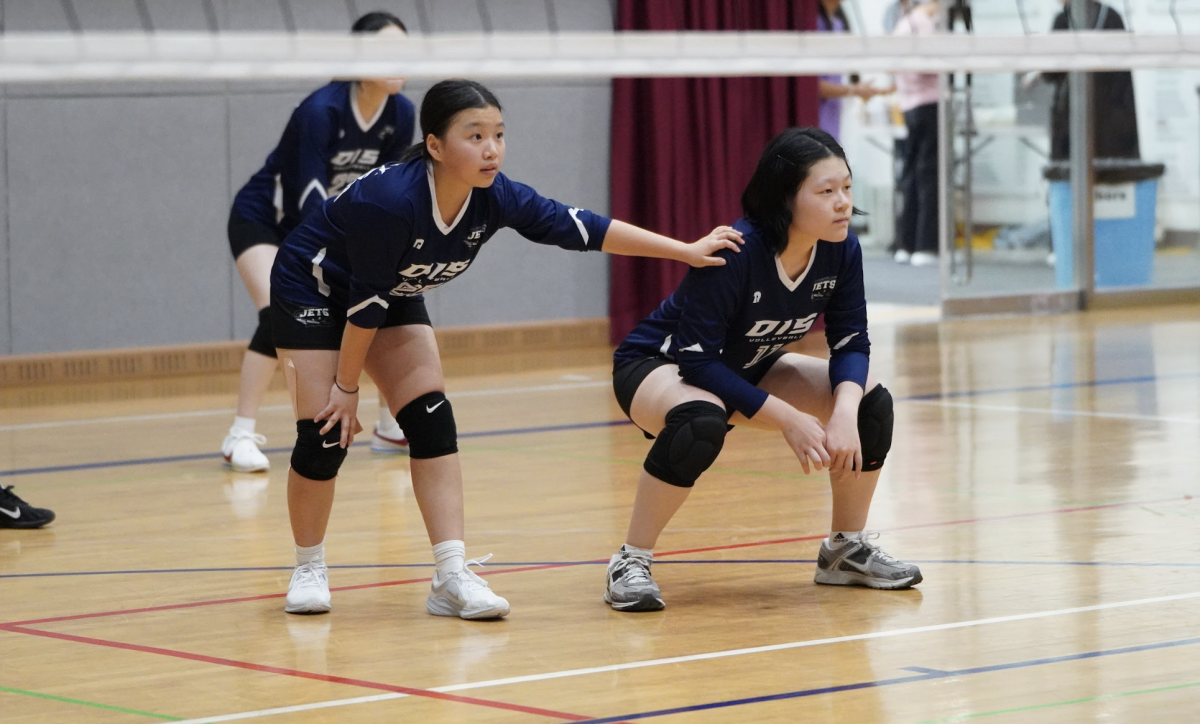 Freshman setter Agnew Kim prepares for a serve receive. She lets her teammate, Sophia Bae, know the timing of the switch for a swift transition from defense to offense. 