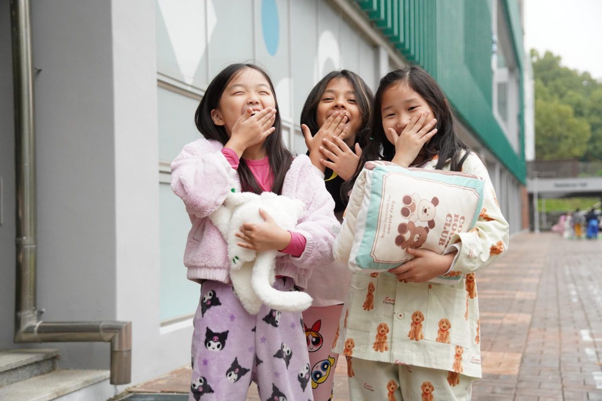 d grade, Shanvi Cha in second grade, and Lucy Kim in third grade yawn after lunch. They cross their fingers that they won't doze off in their last class of the day. Photo by Jessica Woo.