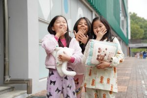 Bella Park in third grade, Shanvi Cha in second grade, and Lucy Kim in third grade yawn after lunch. They cross their fingers that they won't doze off in their last class of the day. 