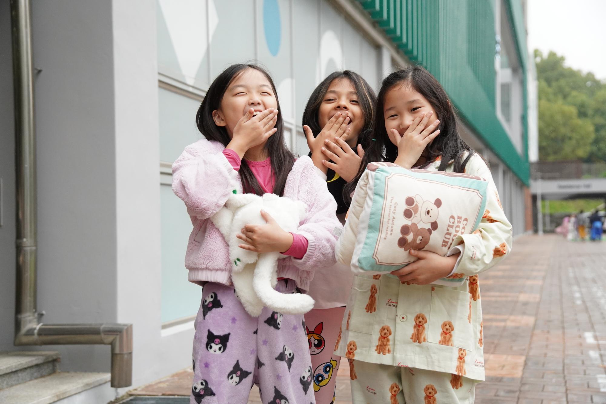 Bella Park in third grade, Shanvi Cha in second grade, and Lucy Kim in third grade yawn after lunch. They cross their fingers that they won't doze off in their last class of the day. 