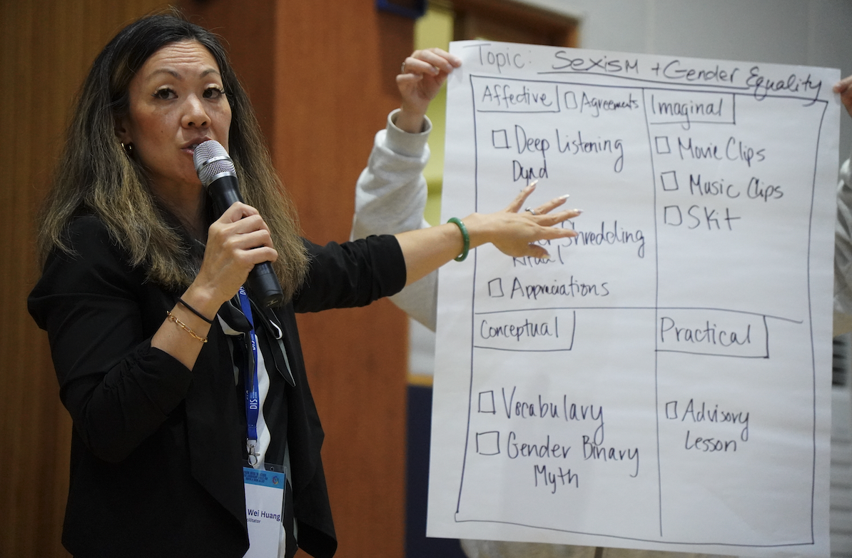 DEIB Consultant Ms. Jessica Wei Huang explains a sample workshop plan she developed. She encourages all participants to come up with their own and implement it during Wednesday all-staff meetings. 