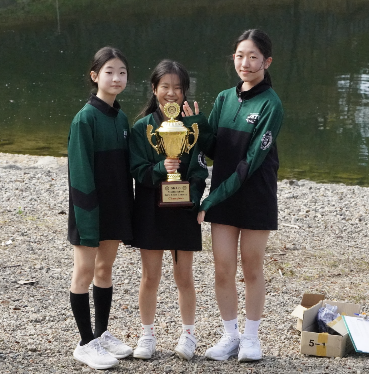 The middle school trio holds up the winning trophy. They prove that team work makes dream work. 