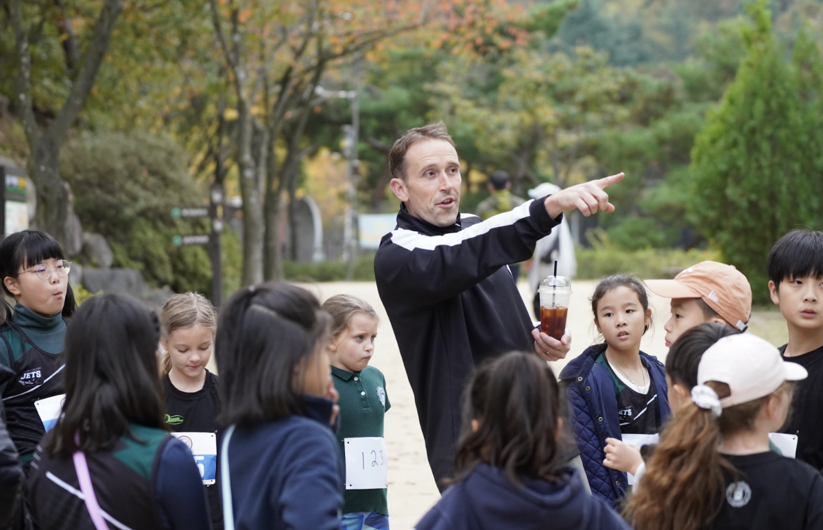 Mr. Crewe guides the kids throughout the trail. Even with the familiarity of the track, he takes precautions to make sure all runners are set and ready. 