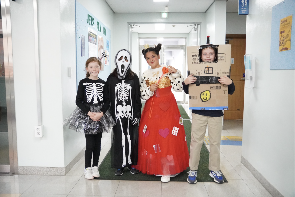 Ghosts, animals and a skeleton unite as the fourth grade class channels their Halloween spirit, each pose a delightful mix of spooky and sweet. 