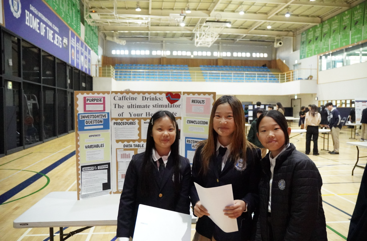 Seventh graders Emily Woo, Esther Kang, and Christina Kim celebrate after a successful presentation. They hope the best for each other, complimenting one other's projects. 