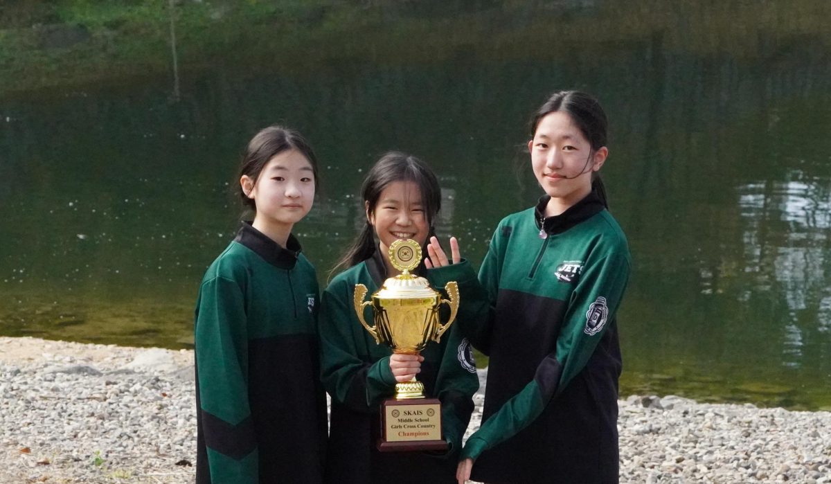 The middle school trio holds up the winning trophy. They prove that team work makes dream work. 