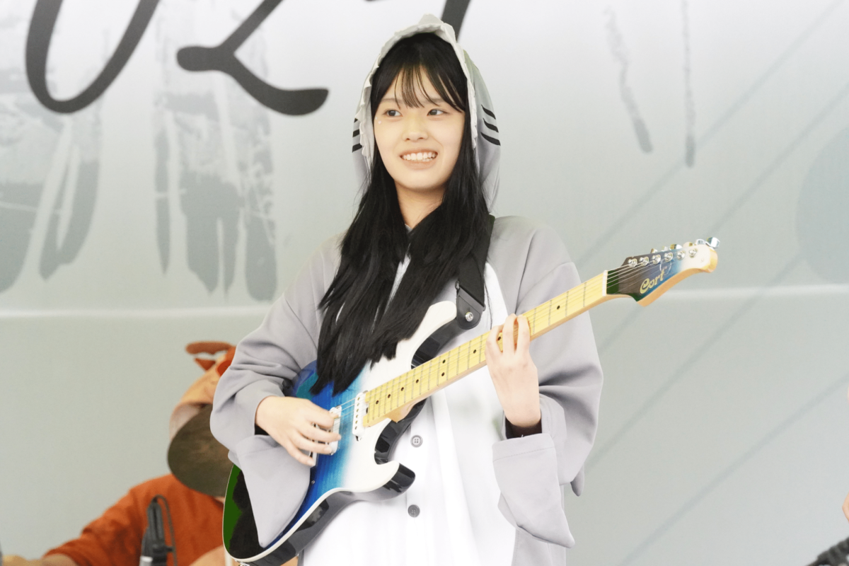 Senior Hailey Tzou strums the electric guitar in her Halloween costume. In addition to the music, the band's cute onesies captivate the audience. 